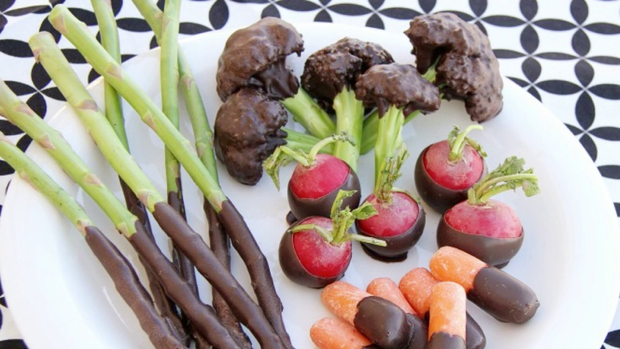 Various vegetables covered with chocolate, arranged on a plate
