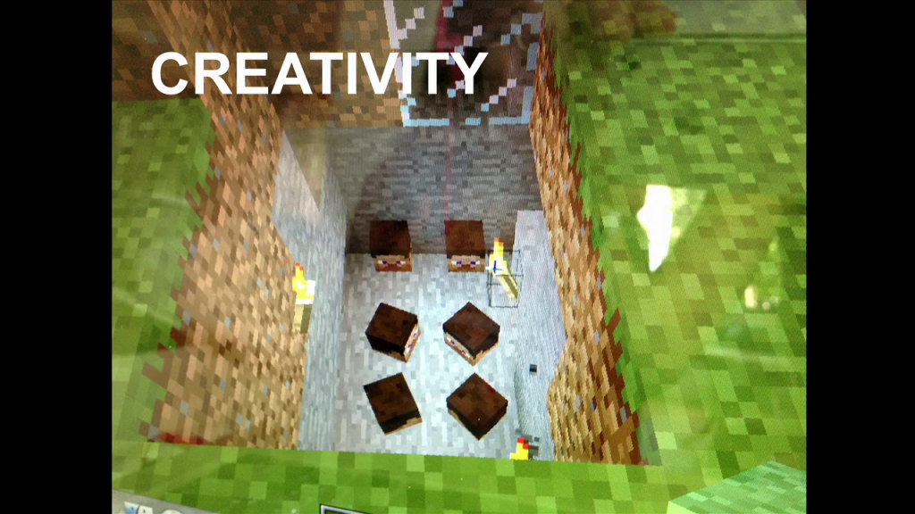 Screenshot of Minecraft captioned "Creativity", showing several heads at the bottom of a pit.
