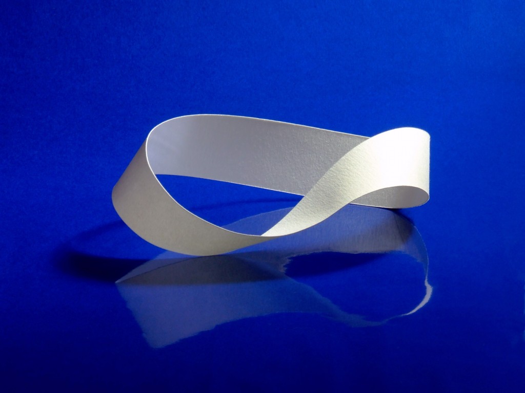 A strip of paper given a half twist and attached at the ends to form a Möbius strip