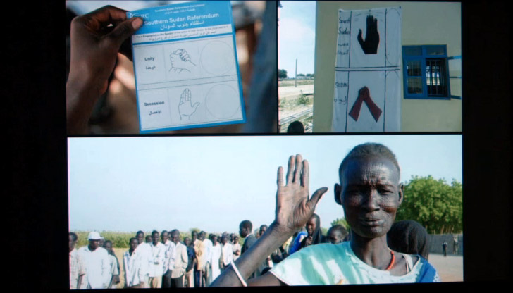 Three images: a card indicating the two hand gestures used in the independence vote; a banner showing same; a woman holding her hand in the secession gesture