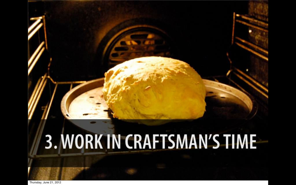 A large round loaf of bread baking in an oven, captioned "work in craftsman's time."