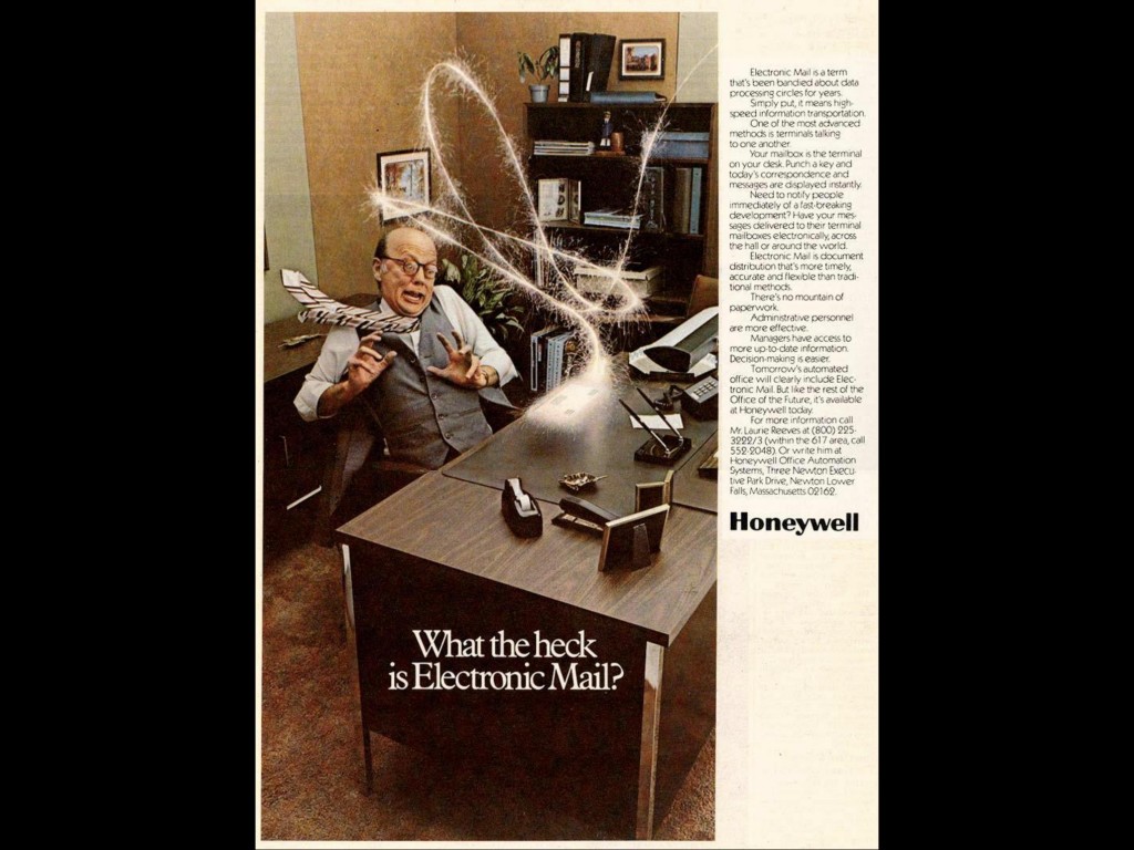 An ad for Honeywell, showing a frightened man flinching away from his desk as sparks fly in from someplace out of frame, ending in a glowing envelope