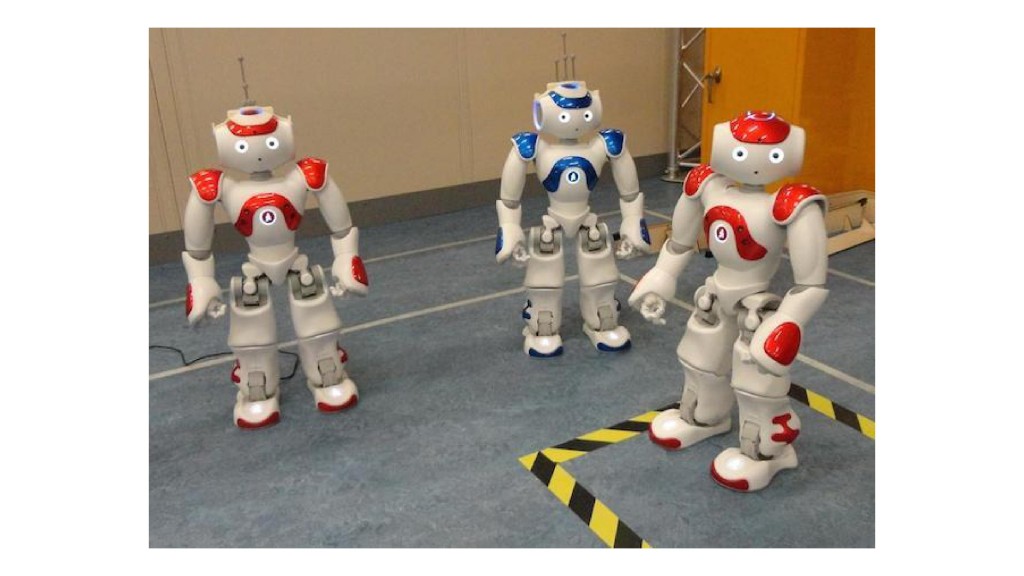 Three robots standing in a room, with one inside a bounded-off "danger zone"