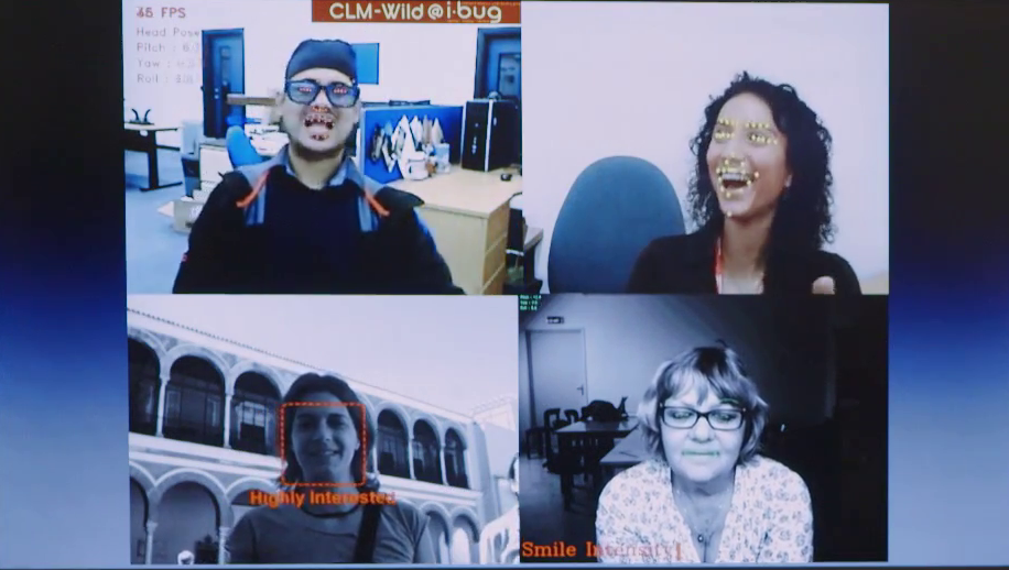 Four video clips playing simultaneously with markers indicating facial detection and captions on some of the panes with evaluation of the person's expression