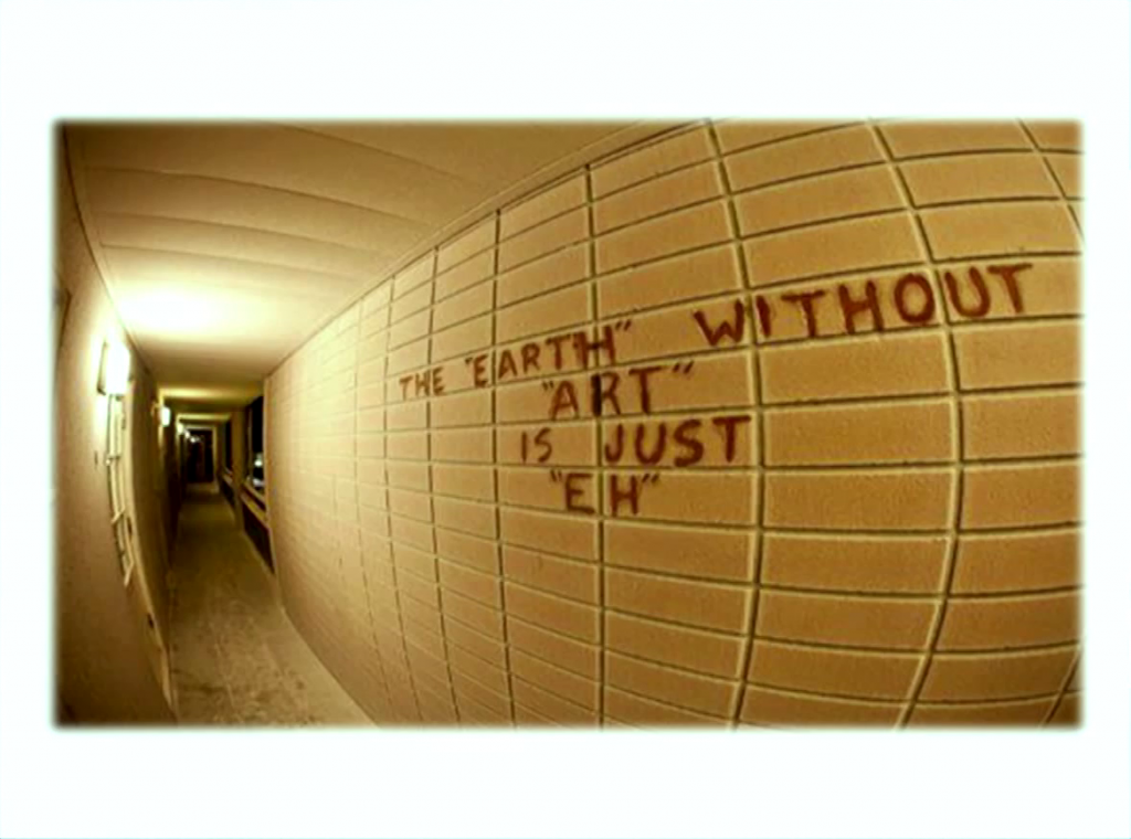 Graffiti on a wal reading "The 'earth' without 'art' is just 'eh'"
