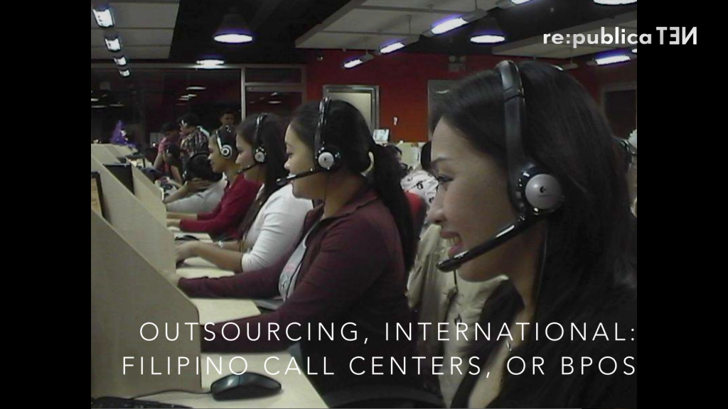 Several women wearing phone headsets, working at a call center.