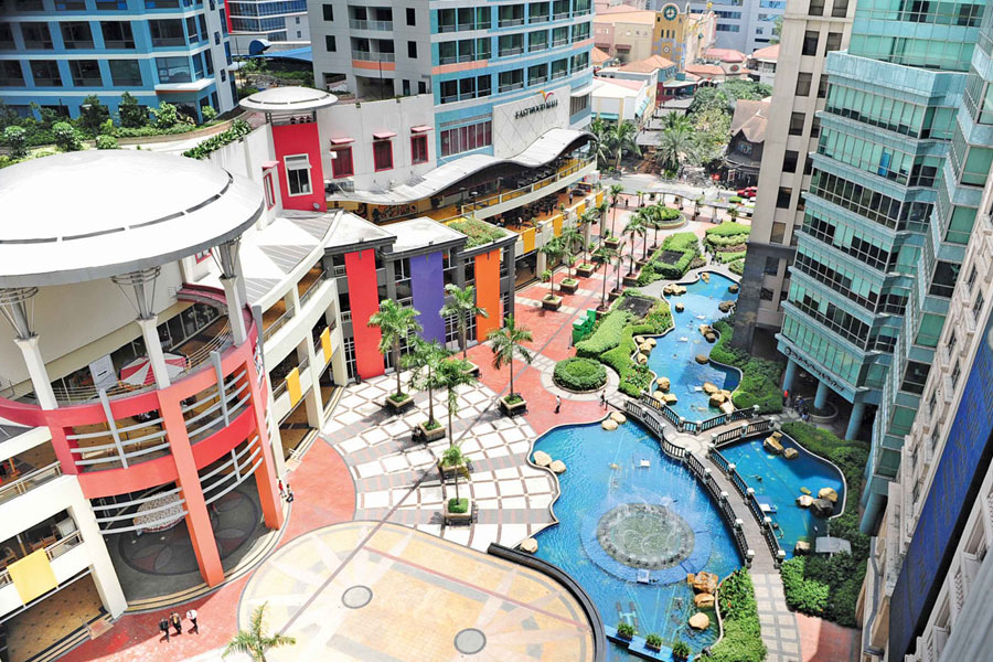 Aerial photo of a plaza between several office buildings with balconies and pools.