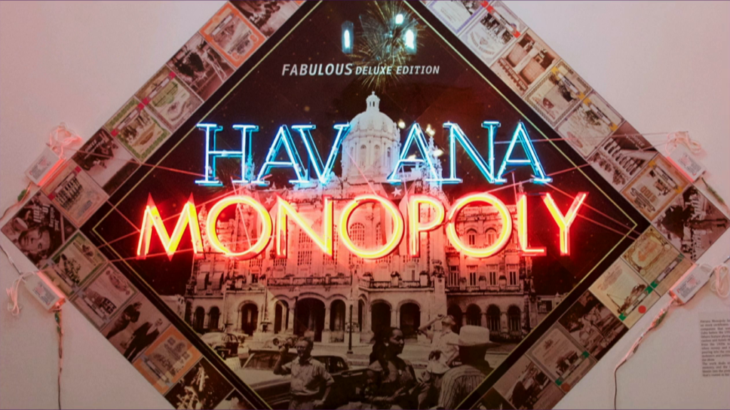 A Monopoly gameboard modified with "Havana Monopoly" in neon in the center, with Cuban locations and personalities in all the property areas.