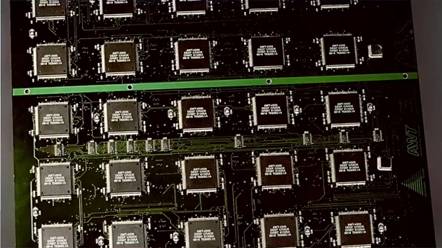 A circuit board with a grid of many processors on it