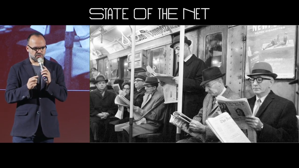 Black and white photo of various people in a subway car.