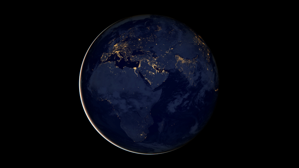 Nighttime space image of the Earth with bright spots visible at larger cities.